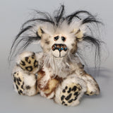 Great Scott is a little, endearingly sweet one of a kind, artist bear by Barbara-Ann Bears in fluffy mohair and wonderful faux fur. He stands just 6 inches/15 cm tall and is 5 inches/18 cm sitting. He is made from dense spotty faux fur with long black plumes of faux fur around his head and a little spotty pink tail.