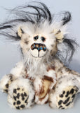 Great Scott is a little, endearingly sweet one of a kind, artist bear by Barbara-Ann Bears in fluffy mohair and wonderful faux fur. He stands just 6 inches/15 cm tall and is 5 inches/18 cm sitting. He is made from dense spotty faux fur with long black plumes of faux fur around his head and a little spotty pink tail.