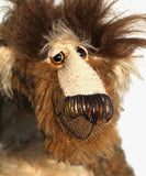 Grooble has beautiful hand painted slightly sparkling glass eyes (they were painted to match his mohair) with eyelids, a wonderfully embroidered nose, sewn from individual threads to match his mohair and an endearing slightly wonky smile, as if he's chewing something.