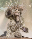 Herbie Hedge is a gentle, beautifully coloured one of a kind mohair artist bear by Barbara-Ann Bears, he stands 10 inches/25 cm tall and is 8 inches/20 cm sitting. Herbie Hedgerow is mainly made from a long, fluffy, distressed pale greyish-green mohair coupled with long, fluffy pale grey mohair and hand-dyed velvet paw pads. Herbie has hand painted eyes with eyelids, a carefully embroidered nose and he a sweet, friendly smile