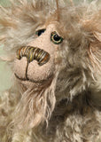 Herbie Hedgerow is a gentle, beautifully coloured one of a kind mohair artist bear by Barbara-Ann Bears, he stands 10 inches/25 cm tall and is 8 inches/20 cm sitting. Herbie Hedgerow is mainly made from a long, fluffy, distressed pale greyish-green mohair coupled with long and fluffy pale grey mohair and hand-dyed velvet paw pads. Herbie has hand painted eyes with eyelids, a carefully embroidered nose and he a sweet, friendly smile
