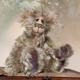 Herbie Hedge is a gentle, beautifully coloured one of a kind mohair artist bear by Barbara-Ann Bears, he stands 10 inches/25 cm tall and is 8 inches/20 cm sitting. Herbie Hedgerow is mainly made from a long, fluffy, distressed pale greyish-green mohair coupled with long, fluffy pale grey mohair and hand-dyed velvet paw pads. Herbie has hand painted eyes with eyelids, a carefully embroidered nose and he a sweet, friendly smile