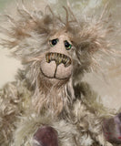 Herbie Hedgerow is a gentle, beautifully coloured one of a kind mohair artist bear by Barbara-Ann Bears, he stands 10 inches/25 cm tall and is 8 inches/20 cm sitting. Herbie Hedgerow is mainly made from a long, fluffy, distressed pale greyish-green mohair coupled with long and fluffy pale grey mohair and hand-dyed velvet paw pads. Herbie has hand painted eyes with eyelids, a carefully embroidered nose and he a sweet, friendly smile