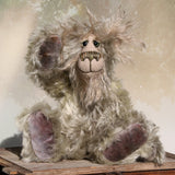 Herbie Hedge is a gentle, beautifully coloured one of a kind mohair artist bear by Barbara-Ann Bears, he stands 10 inches/25 cm tall and is 8 inches/20 cm sitting. Herbie Hedgerow is mainly made from a long, fluffy, distressed pale greyish-green mohair coupled with long, fluffy pale grey mohair and hand-dyed velvet paw pads. Herbie has hand painted eyes with eyelids, a carefully embroidered nose and he a sweet, friendly smile