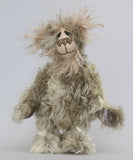 Herbie Hedgerow is a gentle, beautifully coloured one of a kind mohair artist bear by Barbara-Ann Bears, he stands 10 inches/25 cm tall and is 8 inches/20 cm sitting. Herbie Hedgerow is mainly made from a long, fluffy, distressed pale greyish-green mohair coupled with long and fluffy pale grey mohair and hand-dyed velvet paw pads. Herbie has hand painted eyes with eyelids, a carefully embroidered nose and he a sweet, friendly smile