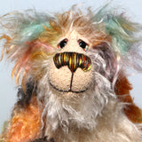 Herbie has beautiful hand painted glass eyes with eyelids, a pert nose embroidered with individual threads to match his mohair and an appealing smile. His face is a long tousled cream mohair and the fronts of his ears and the underside of his tail are made from a longish distressed mohair hand dyed in blue with a little splash of pink