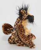 Houdini is mostly made from a lovely soft beige animal print faux fur with very dark brown spots. The sides of Houdini's face and the backs of his ears are a very long black mohair and his tummy and the top of his nose are a long, fluffy blonde mohair. Houdini's footpads are made from gently coloured hand dyed velvet.