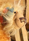 Howard Huckleford is made from a beautifully coloured Harris Tweed and a long, fluffy brown tipped blonde mohair with beige German wool felt paw pads  Howard Huckleford has large, beautiful, hand painted glass eyes (painted to match his colours) with hand coloured eyelids, an impressive nose embroidered from individual threads to match his colouring and a beaming smile