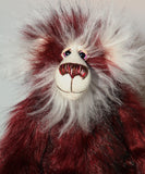 Molly Cuddle is mostly made from a long, silky faux fur which is mainly burgundy in colour but with some very subtle black tipping. Her face, the fronts of her ears and the underside of her tail are an even longer, fluffy white mohair. Molly's burgundy ultrasuede paw pads match her colours perfectly.  Molly Cuddle has beautiful, hand painted eyes with eyelids, a splendid nose embroidered from individual threads to complement her colouring and she has a sweet, friendly smile