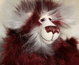 Molly Cuddle is mostly made from a long, silky faux fur which is mainly burgundy in colour but with some very subtle black tipping. Her face, the fronts of her ears and the underside of her tail are an even longer, fluffy white mohair. Molly's burgundy ultrasuede paw pads match her colours perfectly.  Molly Cuddle has beautiful, hand painted eyes with eyelids, a splendid nose embroidered from individual threads to complement her colouring and she has a sweet, friendly smile