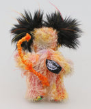 Mousetopheles is made from a short mohair dyed in oranges, yellows and violet and his tummy is a longer mohair dyed gold and orange. The sides of his face are made from a very long mohair dyed orange and the top of his face is a long mohair dyed yellow. The fronts of his ears and his paw pads are a gruesome fabric, the top of his head is a long black faux fur with sprouts of yellow, orange, magenta and purple. Mousetopheles has a long orange pipe-cleaner tail which is wrapped with lilac cotton thread