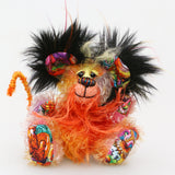 Mousetopheles is made from a short mohair dyed in oranges, yellows and violet and his tummy is a longer mohair dyed gold and orange. The sides of his face are made from a very long mohair dyed orange and the top of his face is a long mohair dyed yellow. The fronts of his ears and his paw pads are a gruesome fabric, the top of his head is a long black faux fur with sprouts of yellow, orange, magenta and purple. Mousetopheles has a long orange pipe-cleaner tail which is wrapped with lilac cotton thread