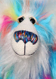 Pedro Piccolo is mostly made from a fairly long and fluffy multi-coloured faux fur in sky blue with flashes of yellow, magenta, orange and mauve. His face, the fronts of his ears and the underside of his tail are a very long and fluffy white mohair. Pedro Piccolo has blue velvet paw pads which complement his colouring perfectly. He has beautiful, hand painted glass eyes with eyelids, a wonderful nose embroidered from individual threads to match his colouring and a charming smile