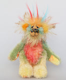 Salsa Verde is a very happy and colourful little one of a kind, hand dyed mohair and faux fur artist bear by Barbara-Ann Bears, he stands 6.5 inches/16 cm tall. Salsa Verde is made from hand dyed mohair, with long plumes of faux fur on his head, hand painted eyes, a multicoloured nose and a beaming smile, a happy bear!