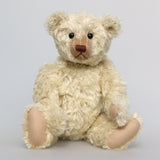 Warburton is a very sweet and loving classical, traditional mohair artist teddy bear by Barbara Ann Bears, he is 17 inches (43cm) tall and is 13 inches (33cm) sitting. Warburton is made from distressed creamy white mohair with beige wool felt paw pads, reproduction black boot button eyes and an embroidered brown nose