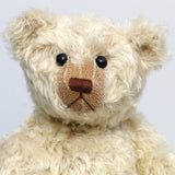 Warburton is a very sweet and loving classical, traditional mohair artist teddy bear by Barbara Ann Bears, he is 17 inches (43cm) tall and is 13 inches (33cm) sitting. Warburton is made from distressed creamy white mohair with beige wool felt paw pads, reproduction black boot button eyes and an embroidered brown nose
