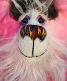 Yummy YumYum is a comical, fabulously pink, one of a kind, artist bear in beautiful hand dyed mohair and faux fur by Barbara-Ann Bears. Yummy YumYum stands 7.5 inches (19 cm) tall and is 6 inches (15 cm) sitting, this doesn't include her wild hair which adds another 3 inches (7.5 cm) to those measurements.