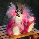 Yummy YumYum is a comical, fabulously pink, one of a kind, artist bear in beautiful hand dyed mohair and faux fur by Barbara-Ann Bears. Yummy YumYum stands 7.5 inches (19 cm) tall and is 6 inches (15 cm) sitting, this doesn't include her wild hair which adds another 3 inches (7.5 cm) to those measurements.