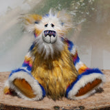 Zebedee is a very shaggy, stripy and colourful, one of a kind, artist teddy bear, he is quite a large and heavy teddy bear, he stands 18.5 inches (47 cm) tall and is 14.5 inches (37 cm) sitting.  Zebedee is made from faux fur in bands of white, magenta, sunny orange and royal blue with white mohair and  orange faux fur