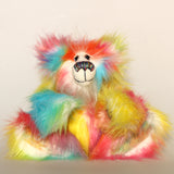 Barbarella is a flamboyant, fun-loving and comical, one of a kind, artist bear by Barbara-Ann Bears in luxurious mohair and rather wild lime faux fur, he stands 12 inches/30 cm tall Barbarella is made from a long and fluffy faux fur which has a white base overlaid with bright yellow, pink, blue and orange. The back of her head, the backs of her ears and the underside of her tail are made from a long rainbow faux fur and her face is as a long white fluffy mohair. Barbarella has hand dyed velvet paw pads. 
