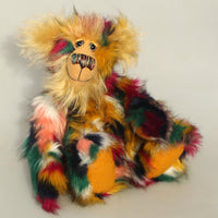 Benedict is made from a beautiful, soft faux fur in green, yellow ochre, red, cream, peach and black, it looks like a patchwork but it's just one piece of fabric. His face the fronts of his ears and the underside of his tail are a luxurious, long fluffy gold mohair and he has gold coloured thick German wool felt paw pads