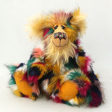 Benedict is a gentle and loving one of a kind, artist bear by Barbara-Ann Bears in luxurious mohair and beautifully colourful faux fur, he stands 17.5 inches/28 cm tall.  Benedict is made from faux fur in green, yellow ochre, red, cream and black, with a luxurious, long gold fluffy mohair and gold felt paw pads