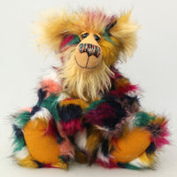 Benedict is a gentle and loving one of a kind, artist bear by Barbara-Ann Bears in luxurious mohair and beautifully colourful faux fur, he stands 17.5 inches/28 cm tall.  Benedict is made from faux fur in green, yellow ochre, red, cream and black, with a luxurious, long gold fluffy mohair and gold felt paw pads