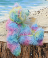 Bluebell is a very large, cuddly and beautifully coloured, 26 inch tall one of a kind, artist bear by Barbara Ann Bears in luxurious fluffy faux fur and mohair.
Bluebell is made from the most gorgeous and luxurious faux fur and mohair, mainly a dense, long and fluffy faux fur in sky blue with delicate magenta, lilac, lime and amber tipping. Her face, the fronts of her ears and the underside of her tail are a long, fluffy pale turquoise mohair. Bluebell has blue velvet paw pads that complement her mohair per