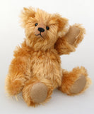 Bruce Fettlewell is a cuddly little traditional one of a kind artist bear in antique gold German mohair on a white background