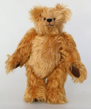 Buddy, a sweet antique gold teddy bear on a white background