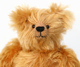 Close-up of a Buddy's face, a sweet antique gold teddy bear on a white background