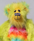 Budgie's face, showing off his luxurious sunny yellow mohair, his beautiful hand painted eyes, his multi coloured nose and his beaming smile 