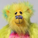 Budgie's face, showing off his luxurious sunny yellow mohair, his beautiful hand painted eyes, his multi coloured nose and his beaming smile 