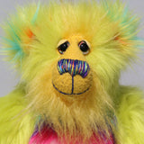 Budgie's face, showing off his luxurious sunny yellow mohair, his beautiful hand painted eyes, his multi coloured nose and his beaming smile 