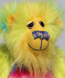 Budgie's face, showing off his luxurious sunny yellow mohair, his beautiful hand painted eyes, his multi coloured nose and his beaming smile 
