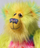 Budgie's face, showing off his luxurious sunny yellow mohair, his beautiful hand painted eyes, his multi coloured nose and his beaming smile 