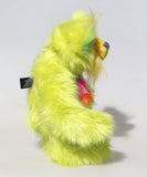 Budgie standing in profile, Budgie is a 14 inch, fun-loving and comical, one of a kind, artist bear by Barbara-Ann Bears in luxurious mohair and rather wild lime and rainbow faux fur