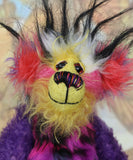 Caramba's face. Caramba is a rather colourful and comical one of a kind artist bear in beautiful purple hand dyed mohair and anmal print faux fur by Barbara Ann Bears