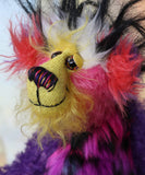 Caramba's face. Caramba is a rather colourful and comical one of a kind artist bear in beautiful purple hand dyed mohair and anmal print faux fur by Barbara Ann Bears