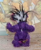 Caramba standing back view. Caramba is a rather colourful and comical one of a kind artist bear in beautiful purple hand dyed mohair and anmal print faux fur by Barbara Ann Bears