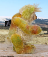 Cardamon standing showing his profile. 
Cardamon is a gentle, happy teddy bear, a beautifully coloured one of a kind, hand dyed mohair artist bear by Barbara-Ann Bears
Cardamon stands 9.5 inches/24 cm tall cm tall 