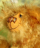 A profile of Cardhu's face showing his sweet smile, Cardhu is a one of a kind antique gold mohair artist bear with hand painted eyes and a sweet smile