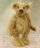 Clever Trevor standing. Clever Trevor is a very sweet traditional one of a kind teddy bear made from wonderfully soft and fluffy mohair by Barbara Ann Bears, he stands 11 inches/ 28 cm tall. Clever Trevor is made from a gorgeous, quite long and feathery mohair, which is a warm gold with a hint of green in colour. Trevor has coffee coloured, German wool felt paw pads and black boot buttons for eyes, like the antique teddy bears