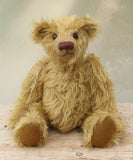 Clever Trevor sitting. Clever Trevor is a very sweet traditional one of a kind teddy bear made from wonderfully soft and fluffy mohair by Barbara Ann Bears, he stands 11 inches/ 28 cm tall. Clever Trevor is made from a gorgeous, quite long and feathery mohair, which is a warm gold with a hint of green in colour. Trevor has coffee coloured, German wool felt paw pads and black boot buttons for eyes, like the antique teddy bears