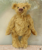 Clever Trevor standing. Clever Trevor is a very sweet traditional one of a kind teddy bear made from wonderfully soft and fluffy mohair by Barbara Ann Bears, he stands 11 inches/ 28 cm tall. Clever Trevor is made from a gorgeous, quite long and feathery mohair, which is a warm gold with a hint of green in colour. Trevor has coffee coloured, German wool felt paw pads and black boot buttons for eyes, like the antique teddy bears