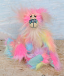 Cordelia sitting.
Cordelia a sweet and colourful one of a kind artist bear in stunning multi-coloured faux fur and gorgeous long fluffy white mohair by Barbara-Ann Bears. Cordelia is 12 inches tall