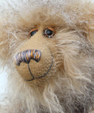 Close up of Cornelius Hoot's face, showing his hand painted eyes with hand coloured eyelids, his beautifully embroidered nose and wonderfully fluffy beige mohair and subtly striped grey and beige faux fur