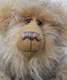 Close up of Cornelius Hoot's face, showing his hand painted eyes with hand coloured eyelids, his beautifully embroidered nose and wonderfully fluffy beige mohair and subtly striped grey and beige faux fur