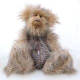 Cornelius Hoot sitting down. He is an endearingly sweet one of a kind, artist bear by Barbara-Ann Bears in wonderfully fluffy mohair and faux fur