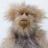 Close up of Cornelius Hoot's face, showing his hand painted eyes with hand coloured eyelids, his beautifully embroidered nose and wonderfully fluffy beige mohair and subtly striped grey and beige faux fur